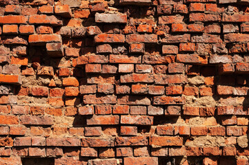 Old destroyed red brick wall