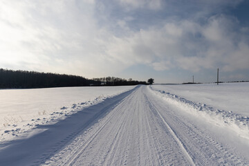 Fototapeta na wymiar winter road after snowfall in sunny weather