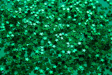 Mardi Gras green stars background. Festive green stars background. Holiday banner with green stars. Mardi gras template for party, design, decor. © Albina