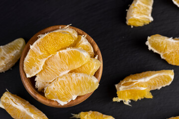 peeled slices of ripe and juicy orange close-up