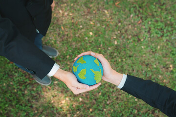 Earth day concept, top view businessman giving Earth globe as CSR corporate social responsible...