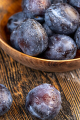 Wet purple plum on the table, fresh harvest