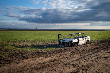 A burned out car. Burnt car in the field. Car fire, vehicle fire due to short circuit. Stolen car intentional arson. One vehicle was damaged in the fire.