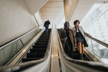 Two stylish professionals ride an escalator, depicting movement and city life with a cool...