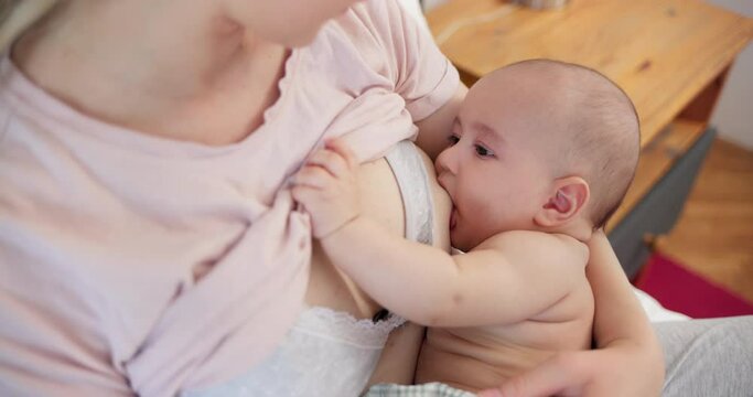 Young mother breastfeeding her little baby boy