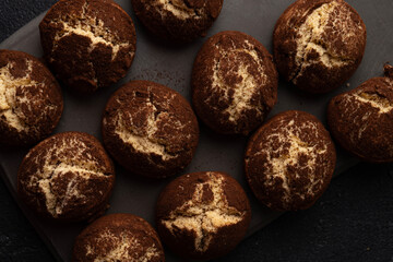 Cinnamon crinkle cookies on a black background flat lay