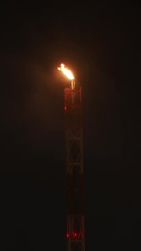 Flare stack at low temperature. Night scene.