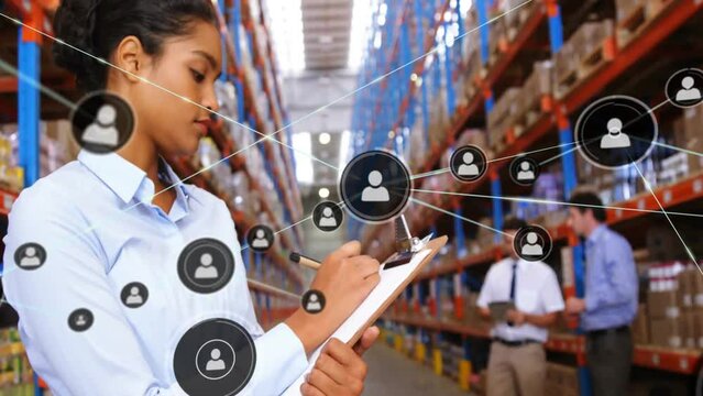 Animation of network of connections with icons over biracial female worker in warehouse - Powered by Adobe