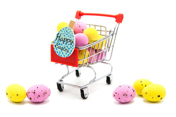 Shopping supermarket cart with red handle with colorful glitter easter eggs isolated on a white...