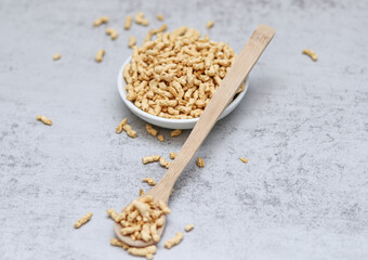 Close up of dried soy bean meat mince on wooden spoon