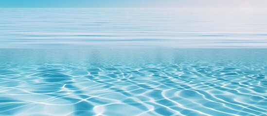 A view of a vast blue ocean with gentle ripples of water in the foreground, showcasing the beauty and serenity of the waters movement.