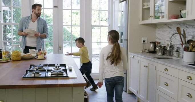 Father, children and breakfast in kitchen for morning or healthy routine for nutrition, pancakes or weekend. Male person, kid siblings and running in home or excited for food meal, hunger or holiday