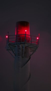Vapor of the cooling tower hides the factory chimney, close-up. Gas and oil refineries. Exhaust gases and steam at very cold weather with night sky.
