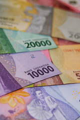 Close up of Rupiah banknotes. The rupiah is the official currency of Indonesia issued and controlled by Bank Indonesia