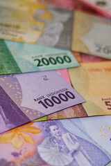 Obraz premium Close up of Rupiah banknotes. The rupiah is the official currency of Indonesia issued and controlled by Bank Indonesia