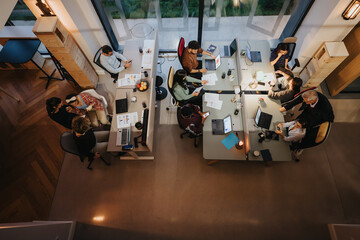Diverse, cross generational, business team working together in a modern office meeting.
