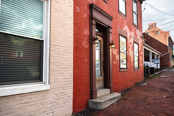 view of the front door in a brick house and facade design.