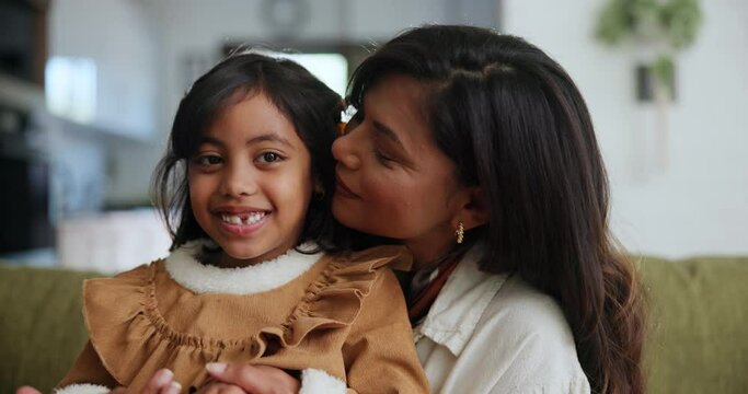 Face, home and hug with mother, girl and relax with love and bonding together in a living room. Portrait, family on a couch and mama with daughter and embrace with happiness, smile and weekend break