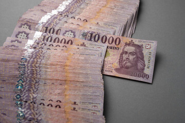 Hungarian banknote bundle money (forint) 10,000 HUF banknotes spread out on a table, close-up as...