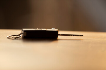 Car key on a wooden table, close-up, selective focus