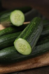 Many fresh cucumbers on wooden table, closeup