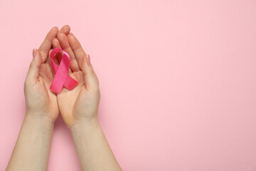 Breast cancer awareness. Woman with pink ribbon on color background, top view. Space for text