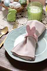 Festive table setting with napkin ring in shape of bunny ears, closeup. Easter celebration
