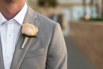 A boutonnière is a floral decoration, typically a single flower or a single stick, worn on the...