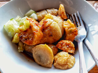 Pempek or Empek-empek is popular savory fishcake from Palembang, South Sumatra, Indonesia. Served on white plate.