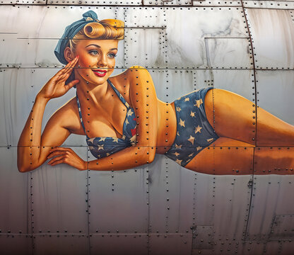 Illustration of vintage World War 2 Bomber Nose Art Pinup girl saluting and wearing a bikini painted on the side of a military aircraft
