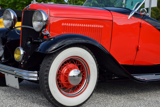 View of front headlight and Goodyear wheel of old 1932 vintage red model B Ford classic car