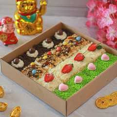 Cut cakes with various toppings in the chocolate box