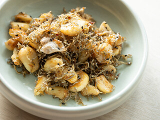 Stir-fried anchovies with garlic on a plate