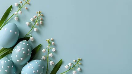 Poster Frame with easter eggs and lily of the valley flowers on pastel blue background. Happy Easter concept. Spring template for greeting card, banner. Top view, flat lay with copy space © ratatosk
