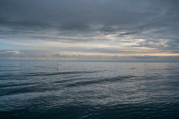 View of the Black Sea on the coast of Sochi against the sunset sky, Sochi, Krasnodar Krai, Russia