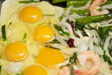 fried eggs with shrimps and vegetables