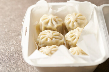 Steamed dumplings in a packaging container