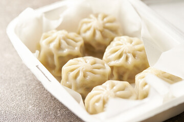 Steamed dumplings in a packaging container