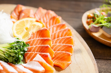 Salmon sashimi on a wooden tray