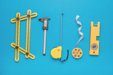A large set of various measuring instruments on a blue background.