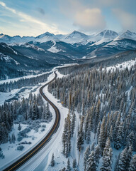 Aerial view of winding road in mountains with snow