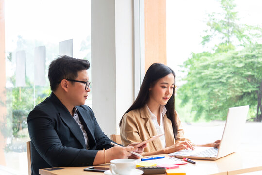 Young manager talking with secretary about report marketing on for planning at office