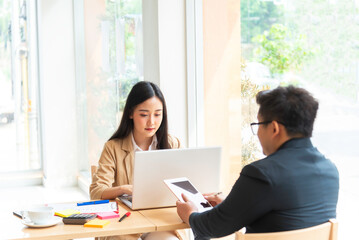 Young manager talking with secretary about report marketing on for planning at office