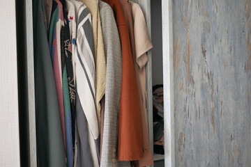  organizing clothes in a closet on shelves for comfort and ease of access