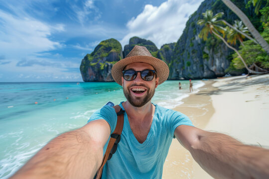 A man taking a selfie with a smartphone on a tropical beach whilst on vacation