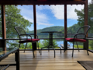 Beautiful screened porch at a cottage overlooking a lake. 