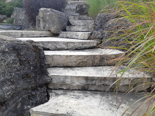 Rustic steps made from large flagstones in large outdoor garden. 