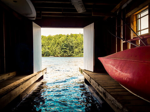 View out to the lake from inside a cottage boathouse in Canada.