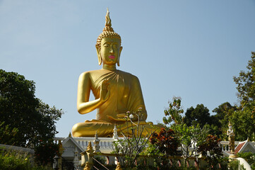 Phra Phut Tha Maha Phratimakhon It is a large golden Buddha image sitting outdoors on a hill. Inside Wat Phra That Doi Saket. This temple is another important one in the Northern part of Thailand. 