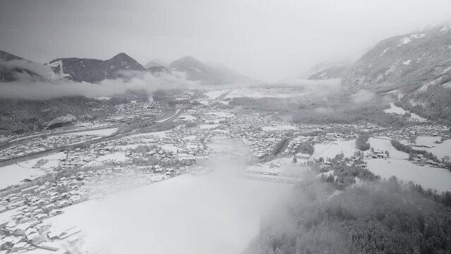 Aerial, Drone, Austria, snow covered valley, flying through clouds, winter